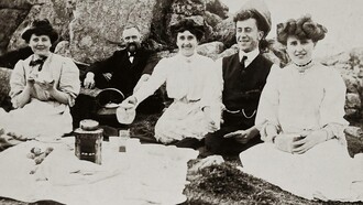 An old photo of friends at a picnic having tea