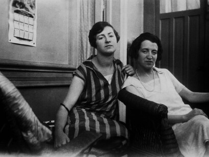 Two women sitting on a couch in an old, vintage photograph, dressed in 1920s vintage fashion, embodying the timeless elegance of old money style and generational wealth