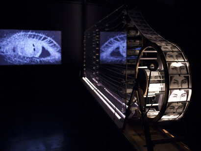 Evangelia Kranioti, Antidote, 2014, Installation (Crank Praxinoscope leading a band of embroidered fabric , video projection)
