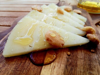 A slice of Jamón Serrano, a piece of Manchego cheese 