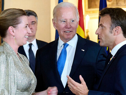 Danish Prime Minister Mette Frederiksen, U.S. President Joe Biden and French President Emmanuel Macron attend a dinner on June 28, 2022, during the NATO Summit in Madrid