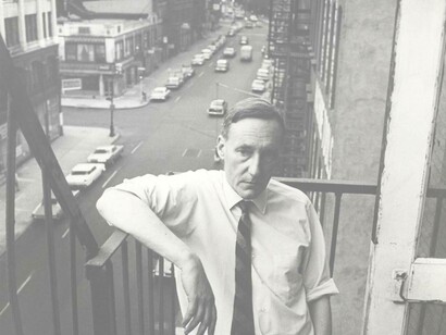 William Burroughs reflecting on society from a stairwell