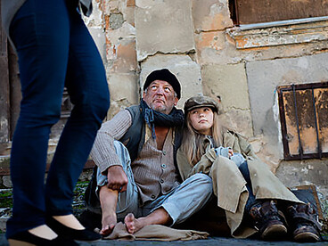 A homeless father and his daughter on the street