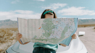A woman holding a map, puzzled about what to do next