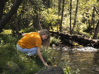 In the quiet of the forest, she gathers more than wildflowers—she gathers the pieces of herself