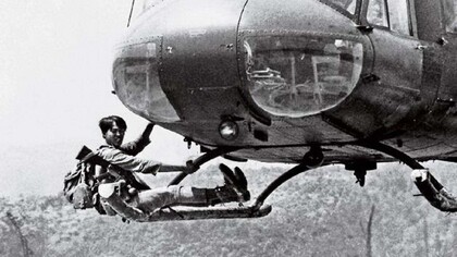 ARVN soldier clings to a departing helicopter while fleeing the Khe Sanh base, March 20, 1971