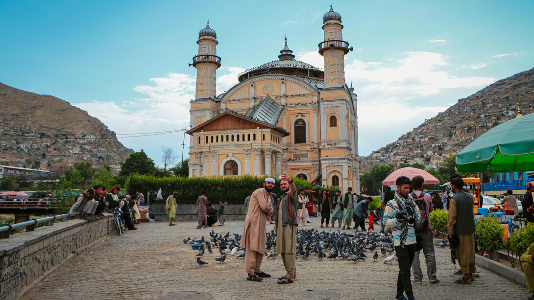 Tourists taking a selfie in front of the Shah-Do Shamshira Mosque in Kabul, Afghanistan