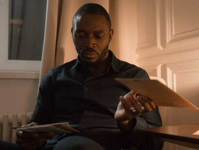 A man looking through treasured correspondence, symbolising the lasting significance of handwritten memories