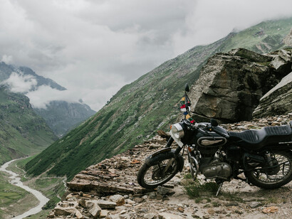 A parked bike overlooking the verdant mountains of the Nepalese Himalayas