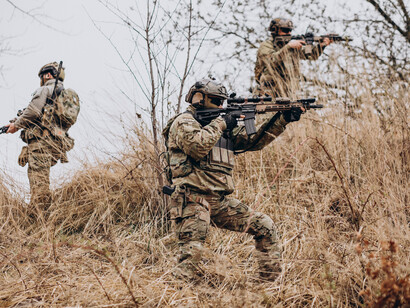 Private military contractors conducting armed operations as security personnel in conflict zones