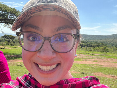 Author Kristen Fiani is in tears, wearing her Maasai host's shuka