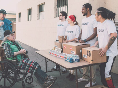 Young volunteers selflessly assisting others by distributing food