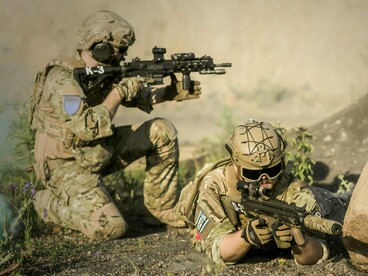 Armed forces observing their surroundings, reflecting the fragile state of international security