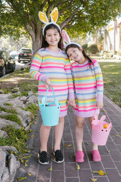 Girls walking along the street while taking part in an Easter egg hun