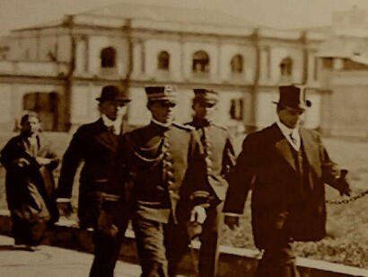 Federico Tinoco (con sombrero de copa) caminando con su escolta por la plaza de la Artillería