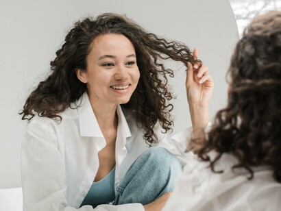 Woman smiling at herself in the mirror