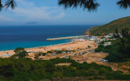 A breathtaking view of Tangier's vibrant beach in Morocco and surrounding landscape under a clear blue sky