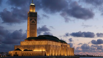 The Hassan II Mosque towering over Casablanca at sunset, showing Morocco’s balance of tradition and modern identity