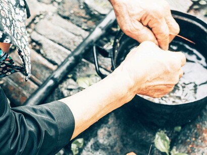 Meal preparation over lit pot