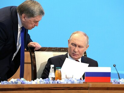 Vladimir Putin is seen irritated as he holds up a paper and shows it to his Aide, Yury Ushakov during a regular session of the Collective Security Council of the Collective Security Treaty Organization, Astana, 28 November 2024