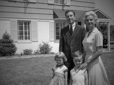 The polished suburban family portrait masks the darker undercurrents of Cold War conformity and consumerist control