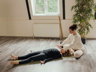 A woman using her energy to heal a client