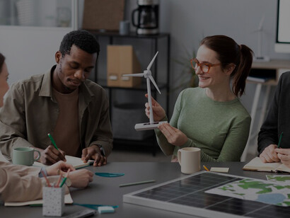 Witness the pursuit of progress as a team of researchers delves into alternative energy sources, engaged in a lively meeting around a table, igniting innovation and forward-thinking strategies