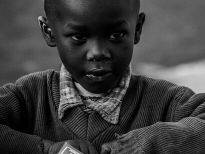 With unwavering determination in his eyes, this young boy gazes toward a future where hope conquers poverty