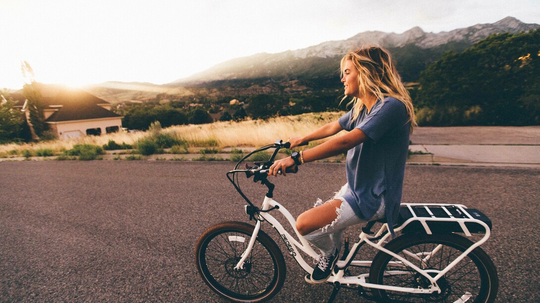 A woman riding her Bup-up bike on her back into town