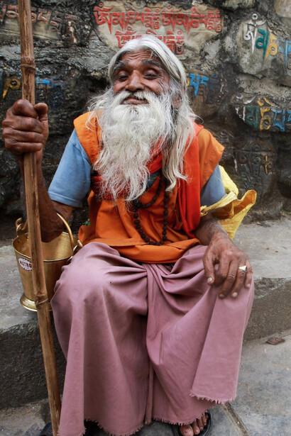 Elderly Monk with a Stick in Varanasi, India