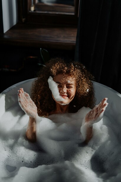 Woman having fun in her bath. Happiness is the mental state to make our lives easier