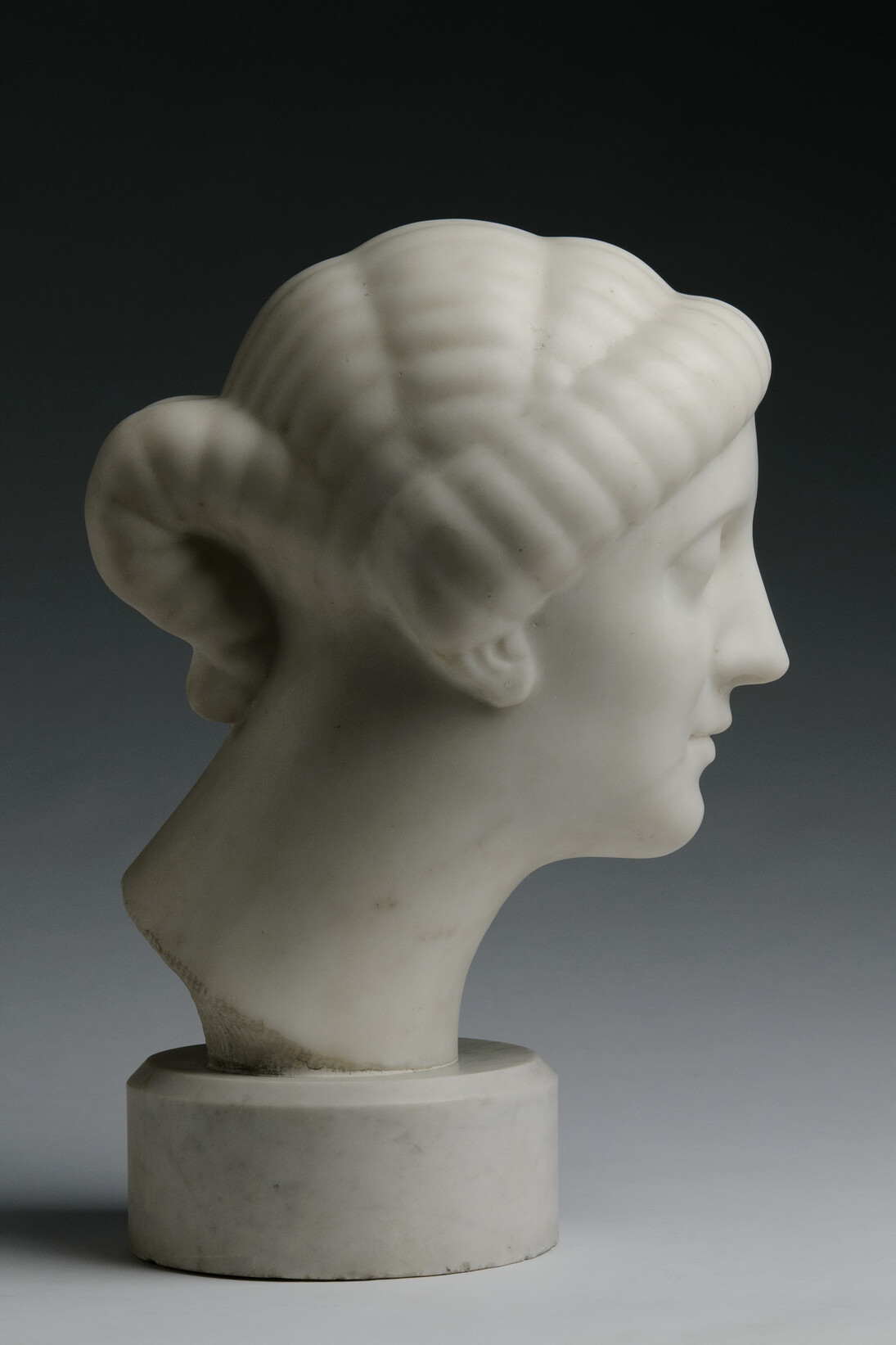 Elie Nadelman, Female Head, c. 1908, white marble, 13 1/2 x 9 1/2 x 12 1/4 inches Round Base: 3 1/4 inches high © Estate of Elie Nadelman, Courtesy of Forum Gallery, New York