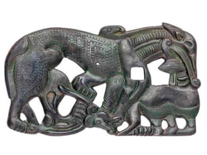 Belt buckle depicting a wolf attacking a yak. Courtesy of The Museum of Fine Arts