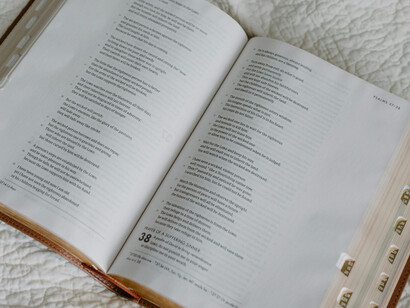 An open Bible atop a white surface