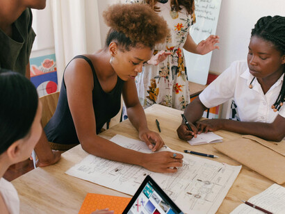 Women working together on a task at an office
