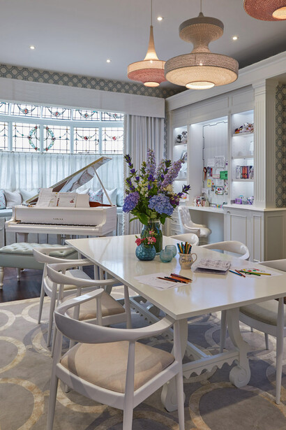 Children's playroom by Katharine Pooley. Features a generous table for school work and a baby grand piano for music lessons