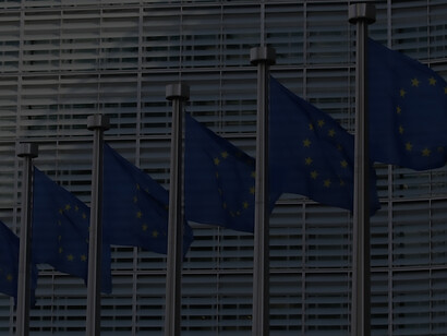In Brussels, Belgium, the flags of the European Union adorn the European Commission's Berlaymont building, symbolizing the unity of member states