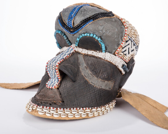 Ceremonial Mask, Bakuba (Kuba) Zaire, Democratic Republic of Congo, wood and burlap with cowrie shells and beads. John L. Warfield Center for African & African American Studies.