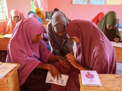 In a bright classroom, Somali girls eagerly absorb knowledge, embodying the resilience of Somaliland's education system amid cultural and historical richness