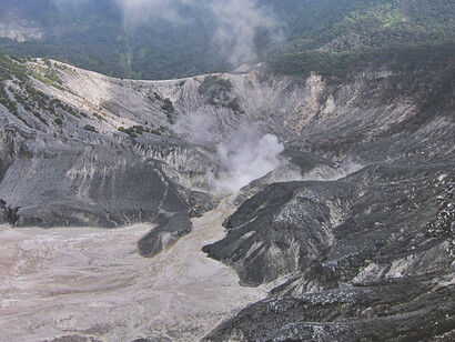 The rugged landscape of Tangkuban Perahu’s craters in Bandung, Indonesia, showcases nature's power, with the vibrant sulphurous steam rising from the deep, and the cool, crisp mountain air adding to the sense of awe