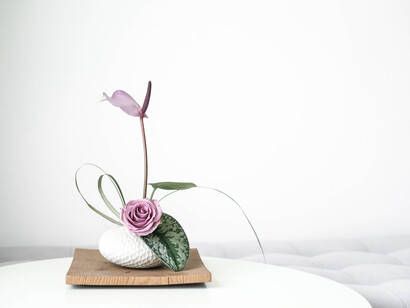 Ikebana is Japanese flower arranging art form, white ceramic dish of flowers