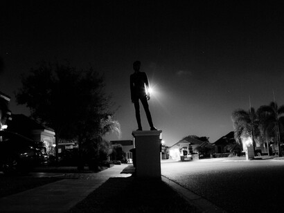 A lone figure stands at the crossroads of illumination and shadow, symbolizing the tension between what we accept and what we repress