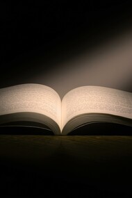 A book in a dark room. Books can provide an understanding of Stoicism and communicate valuable life lessons