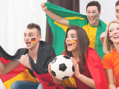 Dynamic energy of soccer enthusiasm as young fans are engrossed in the match on television, encapsulating the electrifying ambiance of sports passion