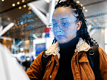 Young traveler using facial recognition technology during airport security screening
