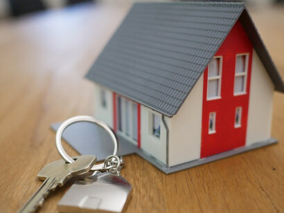 An exquisite miniature white and red wooden house adorns a rustic brown tabletop