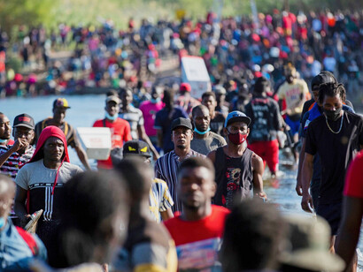 Haitian migrants wait to enter the United States