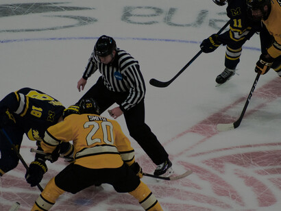 Ice hockey players in full gear during an intense match on the ice