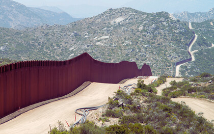 The USA–Mexico border wall in Southern California, cutting through the mountains