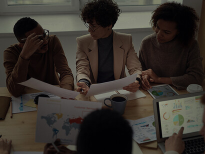 Students of different cultures and backgrounds learning languages with a teacher in a classroom